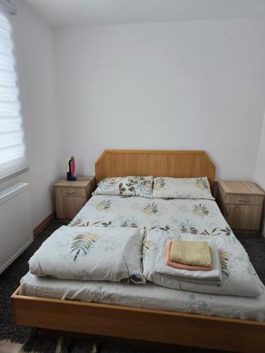 a bedroom with a bed with a wooden frame at Srebrna dolina in Kremna