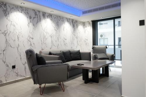 a living room with a couch and a table at Lazuli Urban Luxury -2 bedroom with Pool in Larnaka