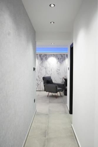 a living room with a chair and a couch at Lazuli Urban Luxury -2 bedroom with Pool in Larnaka