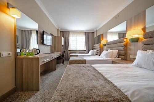 Una habitación de hotel con dos camas y un lavabo. en Grand Yazici Ski Hotel & Spa, en Uludag
