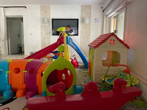 a child playing in a play room with a toy playground at Hotel Nordic in Bellaria-Igea Marina
