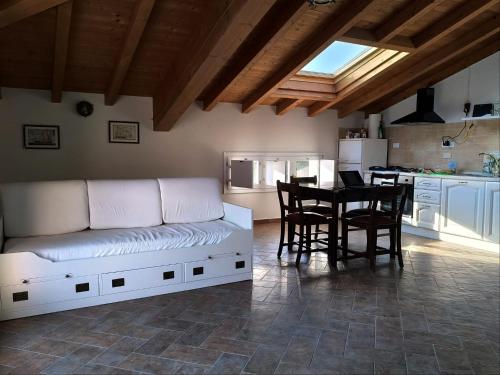 a living room with a white couch and a table at Casa Ingrid in Lerici