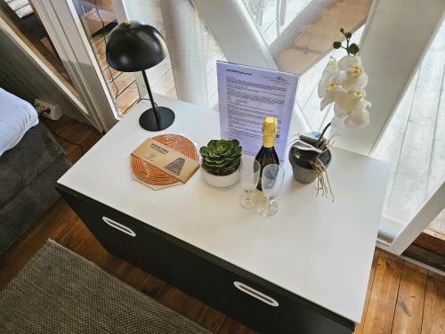 a table with a bottle of wine and a lamp at Mountains and Lakes - Romantika 5 Beach Bungalow in Rust