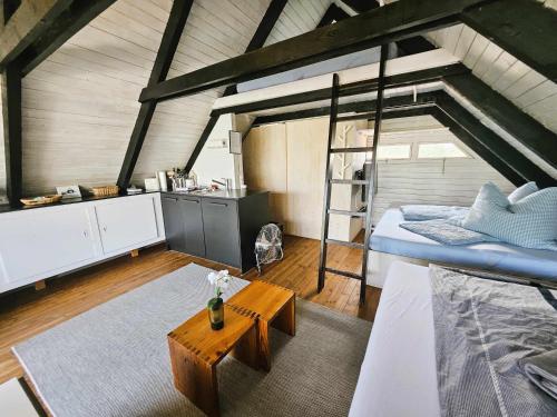 a bedroom with a bunk bed and a table at Mountains and Lakes - Romantika 5 Beach Bungalow in Rust