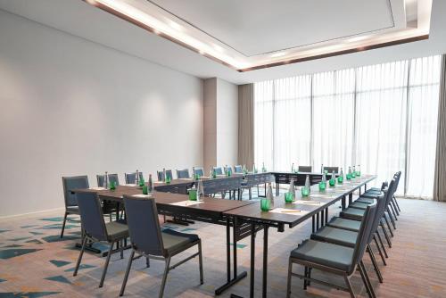 a conference room with long tables and chairs at voco Ma Belle Danang by IHG in Da Nang