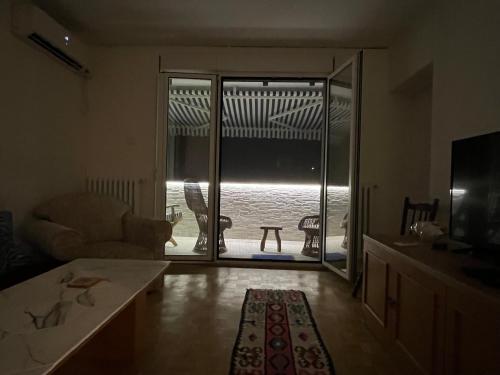 a living room with a sliding glass door with a view of the ocean at Hidden Gem in Dušanovac (historical)