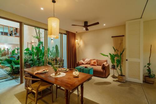 a living room with a table and a couch at Camfusion House in Hoi An