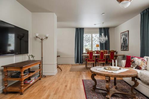 a living room with a couch and a table at Merlo Slott in Timrå