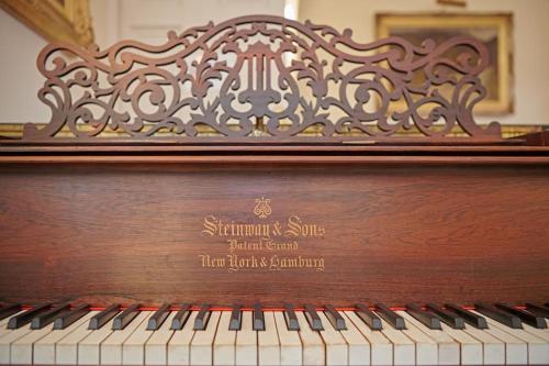 a wooden piano with a sign on the top at Idyllic 12 bedroom Country Home in Forres