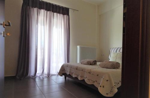 Ένα ή περισσότερα κρεβάτια σε δωμάτιο στο Samaras Apartments in Kamena Vourla