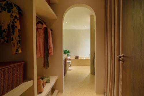 a hallway with a hallway leading to a bathroom at Camfusion House in Hoi An