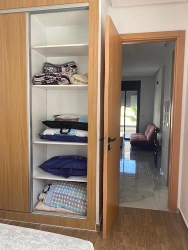 a closet with a door open to a room at Luxury Appart à louer - Mdiq in M'diq