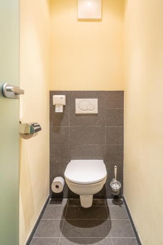 a bathroom with a white toilet in a stall at Der Kirchheimerhof - Superior in Bad Kleinkirchheim