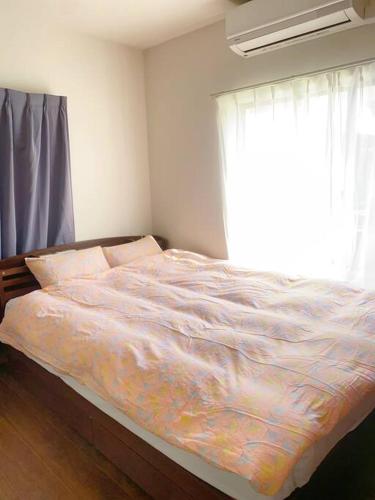 Postel nebo postele na pokoji v ubytování 小岩民泊宿