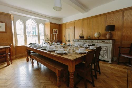 a large dining room with a long wooden table at Large Manor House near Bath in Trowbridge