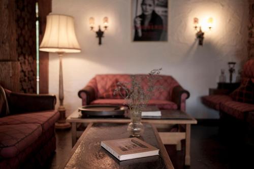 a living room with a couch and a coffee table at Mittelburg Wellnesshotel in Oy-Mittelberg