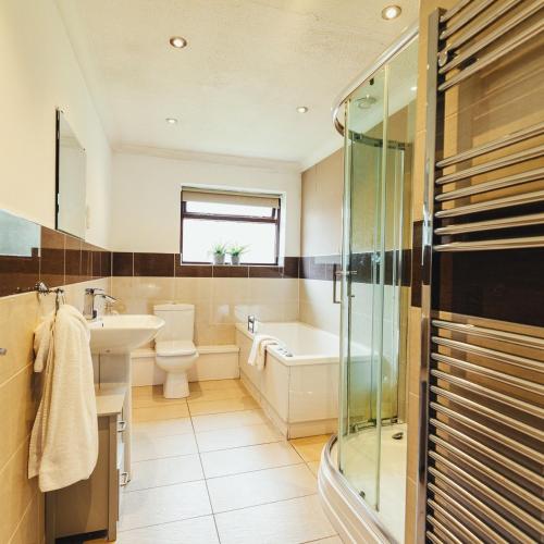 a bathroom with a sink toilet and a shower at Birchwood Cottage with hot tub in Valley