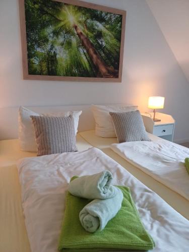 a bedroom with two beds with towels on them at Landhaus Tewel Hotel mit Restaurant 14KM vom Heide-Park in Tewel