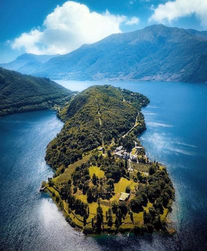 an island in the middle of a large body of water at Akasa on Lake Como in Menaggio
