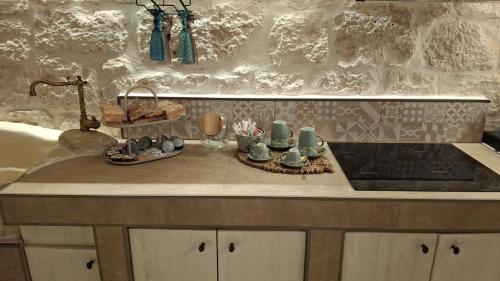 a kitchen counter with a tray of items on it at Diamond Suite Puglia in Ceglie Messapica