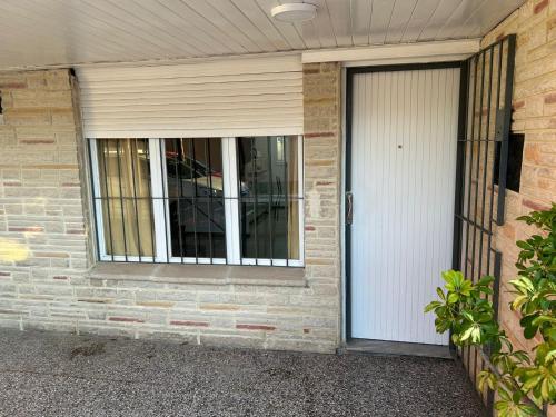a house with a white door and a window at Ph Completo Petfriendly in Mar del Plata
