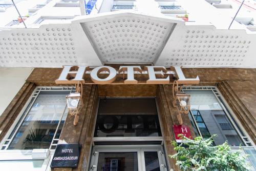 a hotel sign on the front of a building at Hôtel Ambassadeur in Paris