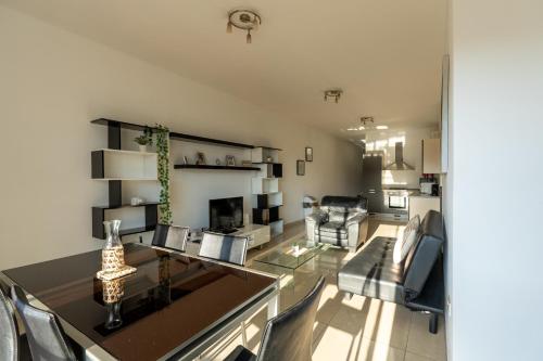 a living room with a table and chairs in a room at Brightest Room, Shared Bathroom Gzira in Il-Gżira
