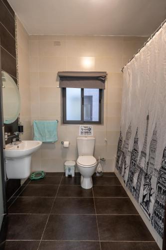 a bathroom with a toilet and a sink at Brightest Room, Shared Bathroom - Shared Flat - Gzira in Il-Gżira