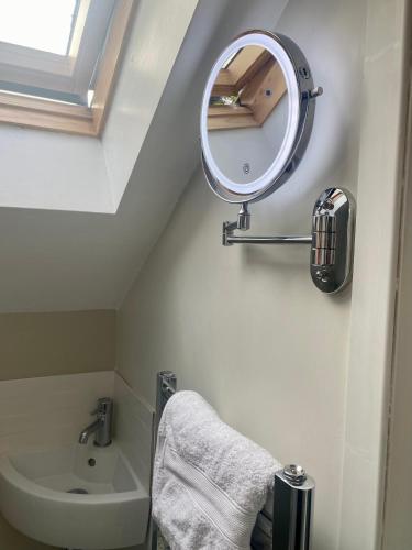a bathroom with a mirror and a sink at Wendys house in Sarisbury Green