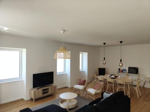a living room with a couch and a table at Casa Amarela in Cortegaça