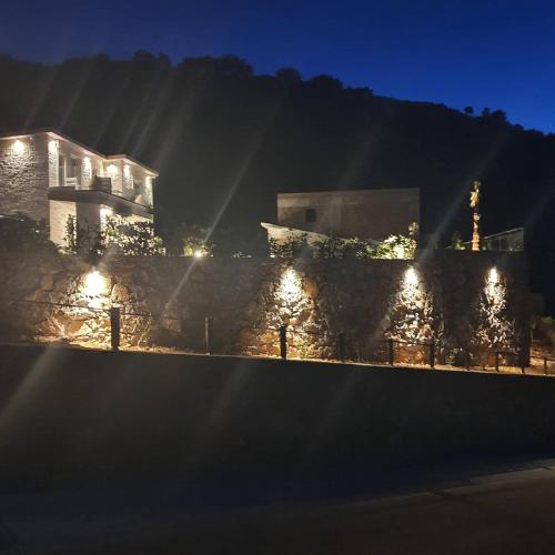 a building with lights on it at night at Villa petros in Malia