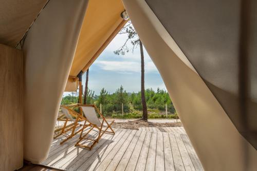 a view of a deck with chairs on a house at Ohai Nazaré Outdoor Resort in Nazaré
