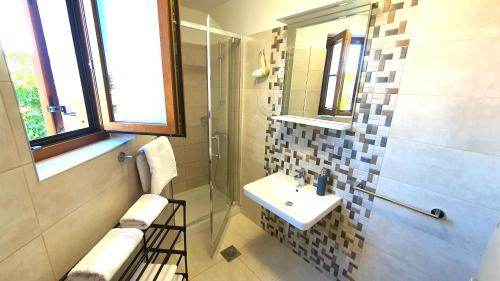 a bathroom with a sink and a shower at Apartments Villa Tre Marie in Rovinj