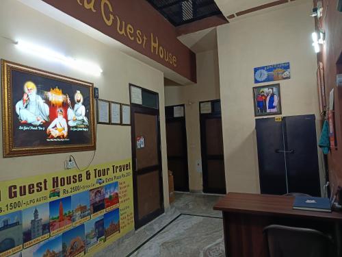 a lobby of a hotel with a sign on the wall at SIDHU GUEST HOUES -400 walking distance From golden Temple in Amritsar