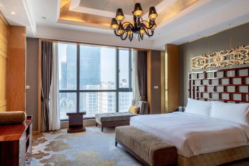 a bedroom with a large bed and a large window at Crowne Plaza Shenzhen Longgang City Centre by IHG in Longgang