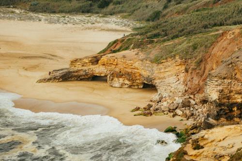 an aerial view of a beach next to the ocean at Ohai Nazaré Outdoor Resort in Nazaré