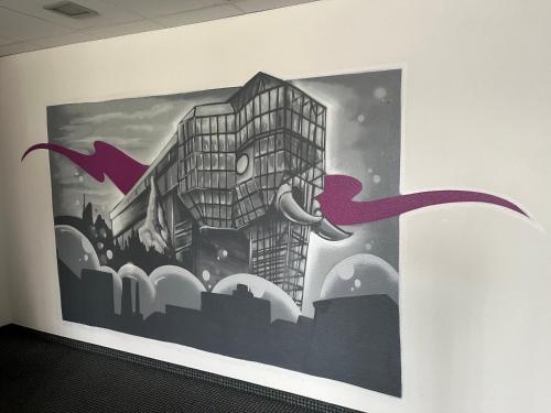 a painting of a building on a wall at Hotel Herzog in Hamm