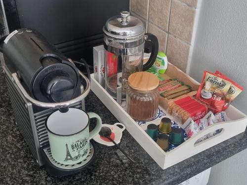 a kitchen counter with a coffee maker and a blender at Ocean Escape in Strand