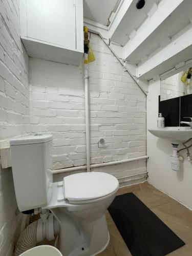 a bathroom with a white toilet and a sink at House se3 8rp in London