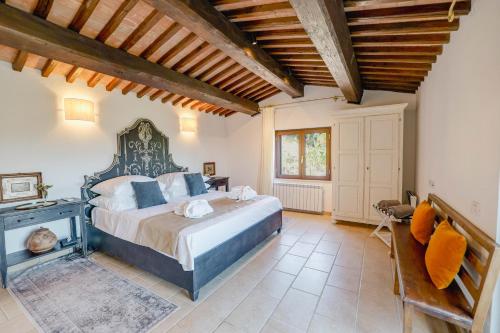 a bedroom with a large bed and a fireplace at Villa Destino Italy, Umbria Tuscany boarder in Montone