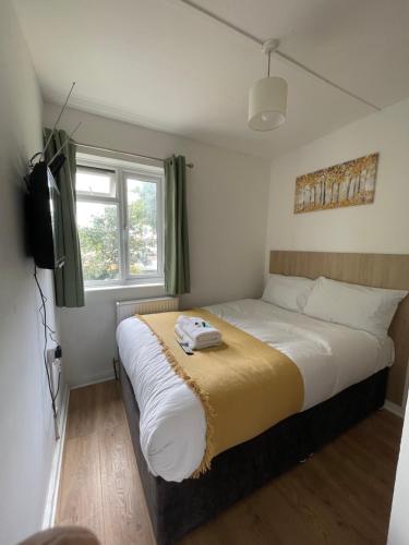 a bedroom with a bed and a television in it at House se3 8rp in London
