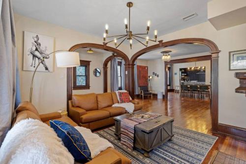 a living room with a couch and a table at AC 9 BR 4BA Victorian Manor - 1 Block to Beach in Atlantic City