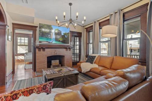 a living room with a couch and a fireplace at AC 9 BR 4BA Victorian Manor - 1 Block to Beach in Atlantic City