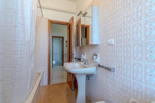 a bathroom with a sink and a mirror at Mare e Monti a due Passi dalla Spiaggia! Ligurian Vacation Apartment in Chiavari