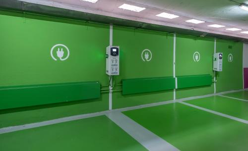 an empty room with green walls and toilets at Carlemany Girona in Girona