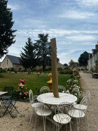 a table and chairs with a candle on top of it at Château de la Thibaudière - Studio de Madame de Savary in Allonnes