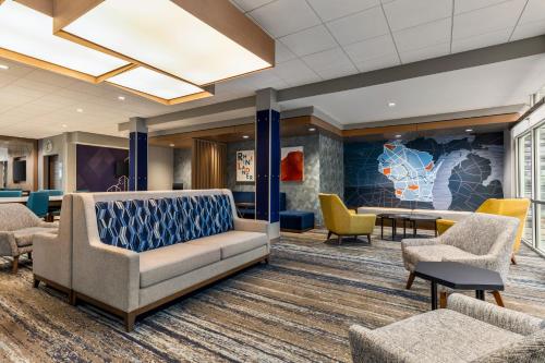 a waiting room with a couch and chairs at Holiday Inn Express & Suites Rhinelander by IHG in Rhinelander