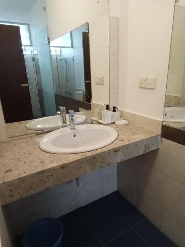 a bathroom with two sinks and a large mirror at Mount Marina Villas 12 in Galle