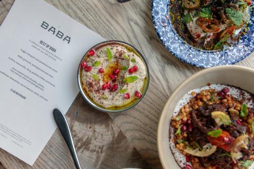 a table with two plates of food and a menu at Kimpton Charlotte Square by IHG in Edinburgh