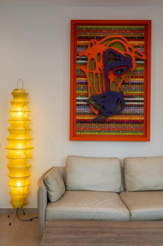 un salon avec un canapé et un tableau au mur dans l'établissement Appartement une chambre, proche métro, à Lille